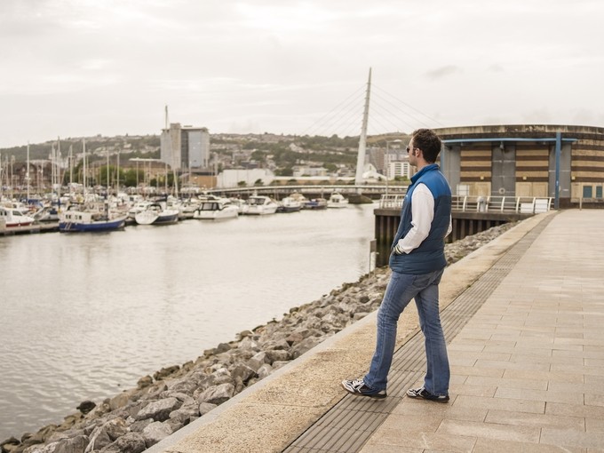 Student overlooking marina 