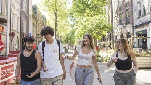 four students walking through swansea town 