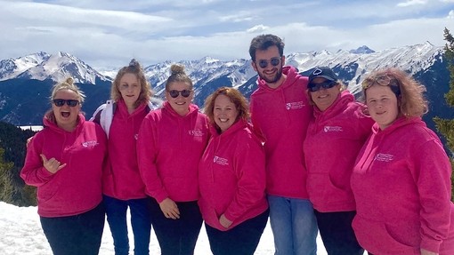 Group of students standing in the snow and posing for a photo