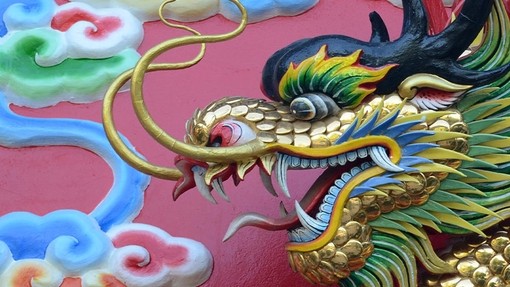 A painted carving of a Chinese dragon with gilt scales. 