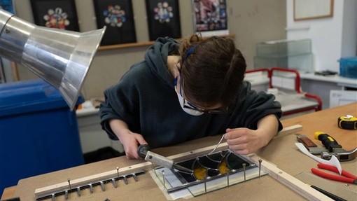 Student working on a glass project