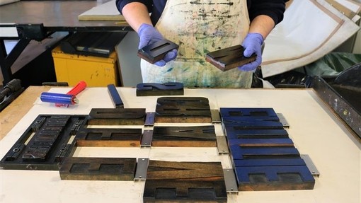 Student working with typesetting blocks