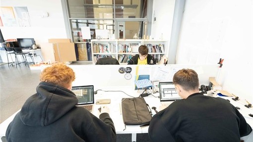 Students on their laptops and working on a project