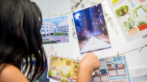 Student looking at illustrative postcards