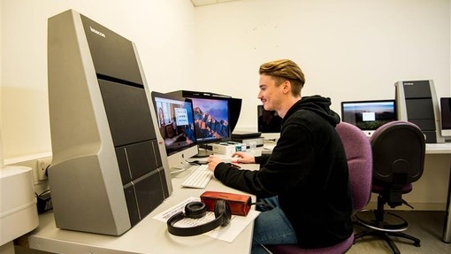 Student editing photos on a computer 