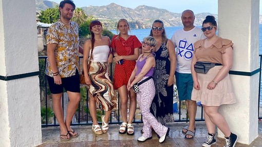Students posing for a photo in Spain with a sea backdrop