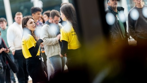 Student ambassadors chatting with students in the background