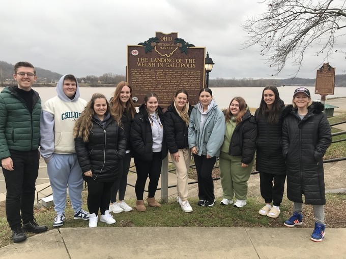 Students next to historic sign