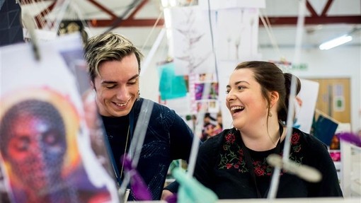 Two students laughing together