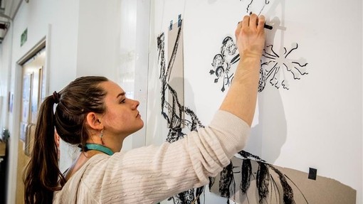 Student sketching on the wall