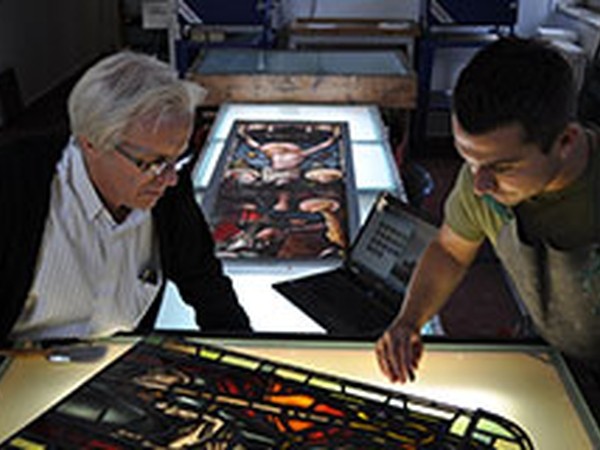 Staff and student working with glass 